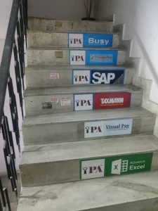Staircase to IPA with step signs for Busy, SAP, Taxmann, Visual Pay and Advanced Excel